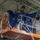 USS Ronald Reagan (CVN 76) Sailors hang banner in the hangar bay