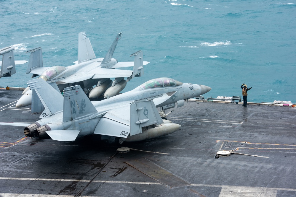 Sailor Directs An F/A-18F Super Hornet On The Flight Deck