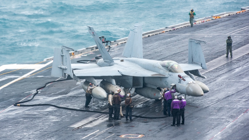 Sailors Refuel An F/A-18E Super Hornet On The Flight Deck