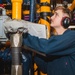 U.S. Sailor Inspects Pipe Readout