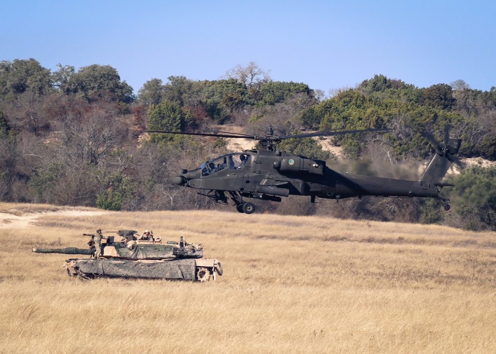 Apache Helicopter Flies over an M1A2 SEP V3