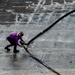 U.S. Navy Sailor Removes Kink From JP-5 Hose