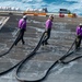 U.S. Navy Sailors Remove Jet Fuel Hose From Flight Deck