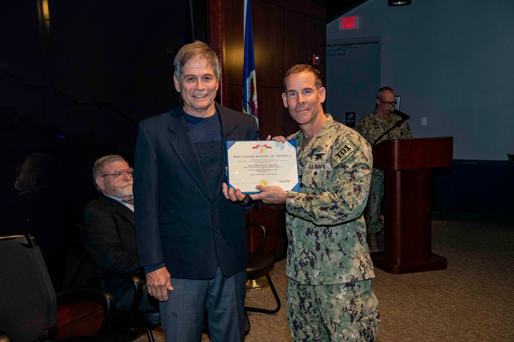 Mr. Wendell Hedge, a former Radioman 2nd Class, receives the Bronze Star Medal (Gold Star in lieu of the third award with Combat “V”) for heroic achievement while deployed to Vietnam