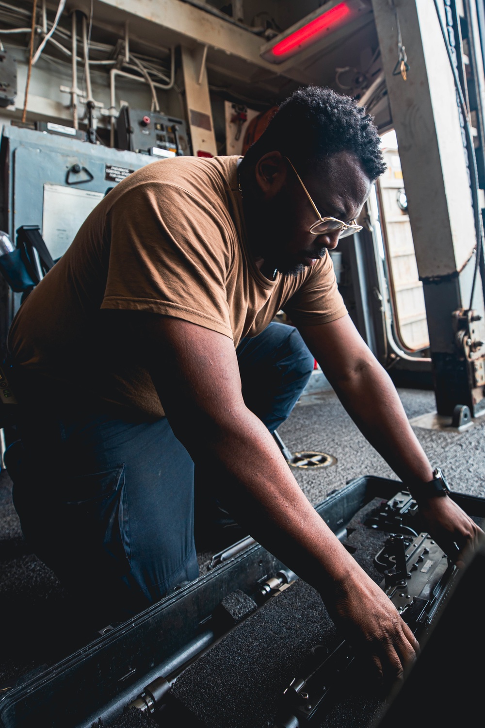 U.S. Navy Sailor disassembles M-240