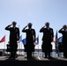 Sailors render salute during National Anthem