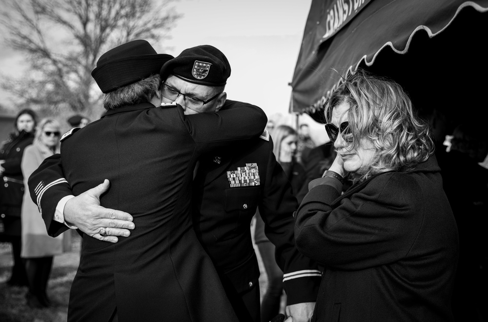 Iowa Soldiers embrace after memorial service