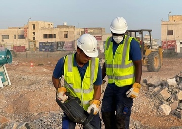 Worker in USAID Construction Vest Drills in Abuselim, Libya
