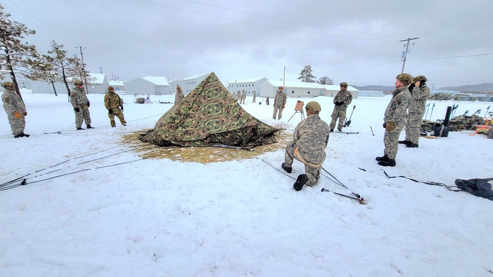 Airmen learn to build Arctic 10-person tents during cold-weather training at Fort McCoy