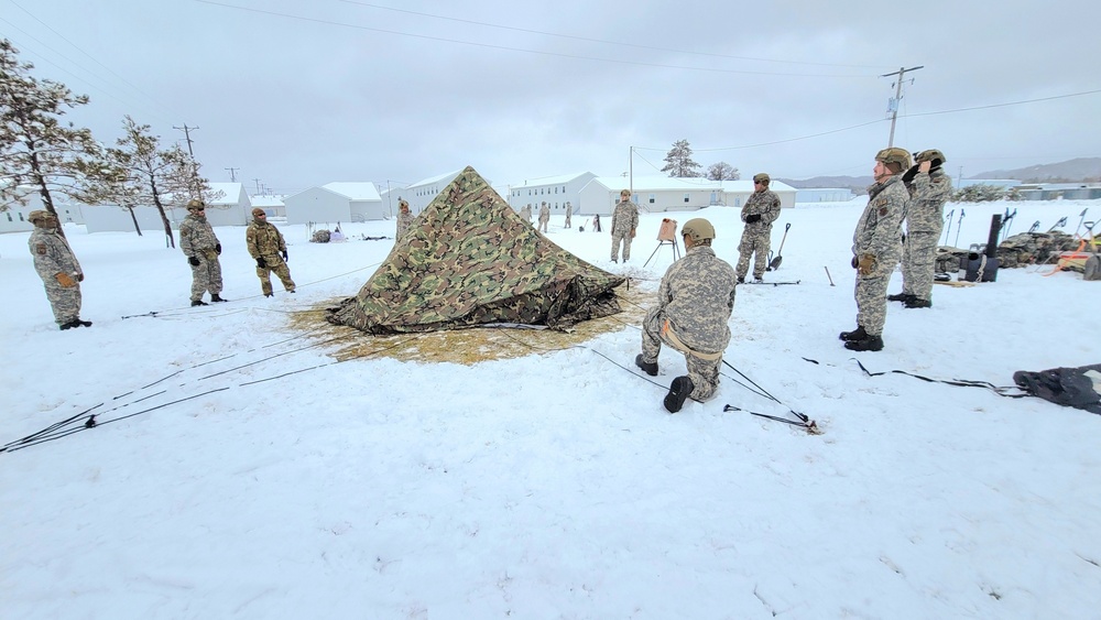 Airmen learn to build Arctic 10-person tents during cold-weather training at Fort McCoy