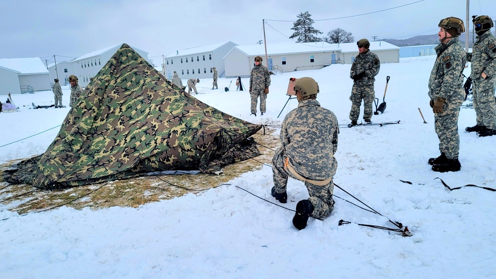 Airmen learn to build Arctic 10-person tents during cold-weather training at Fort McCoy