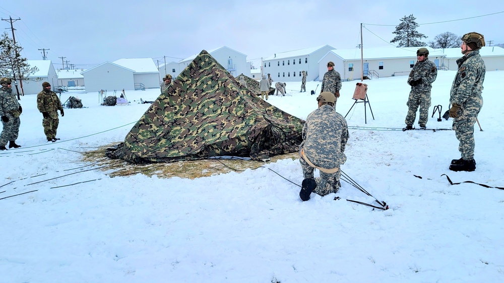 Airmen learn to build Arctic 10-person tents during cold-weather training at Fort McCoy