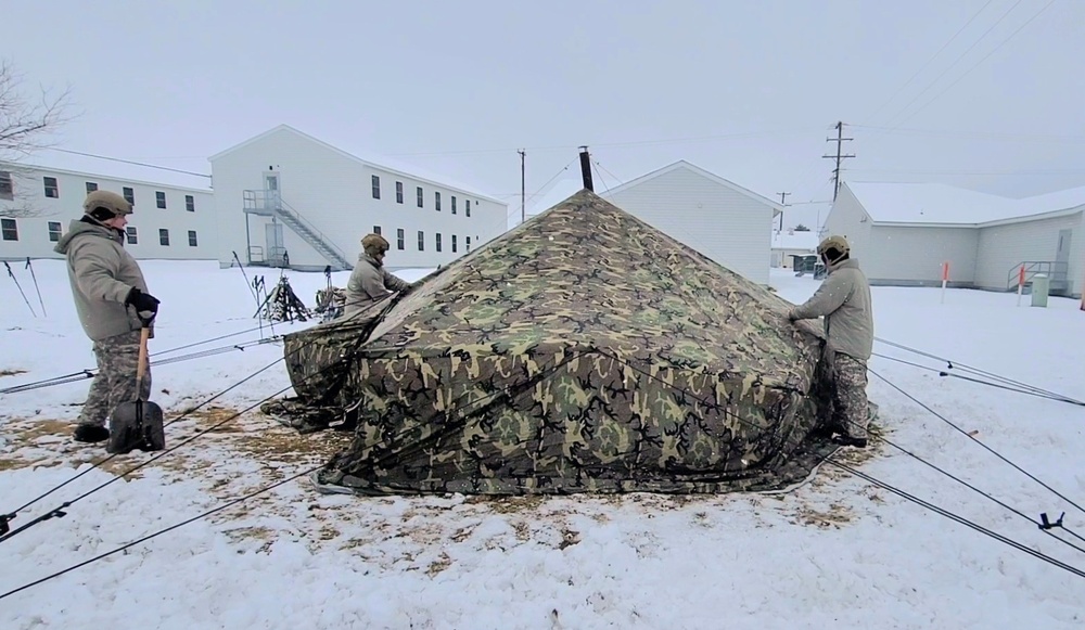 Airmen learn to build Arctic 10-person tents during cold-weather training at Fort McCoy