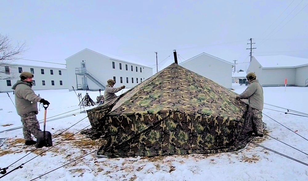 Airmen learn to build Arctic 10-person tents during cold-weather training at Fort McCoy