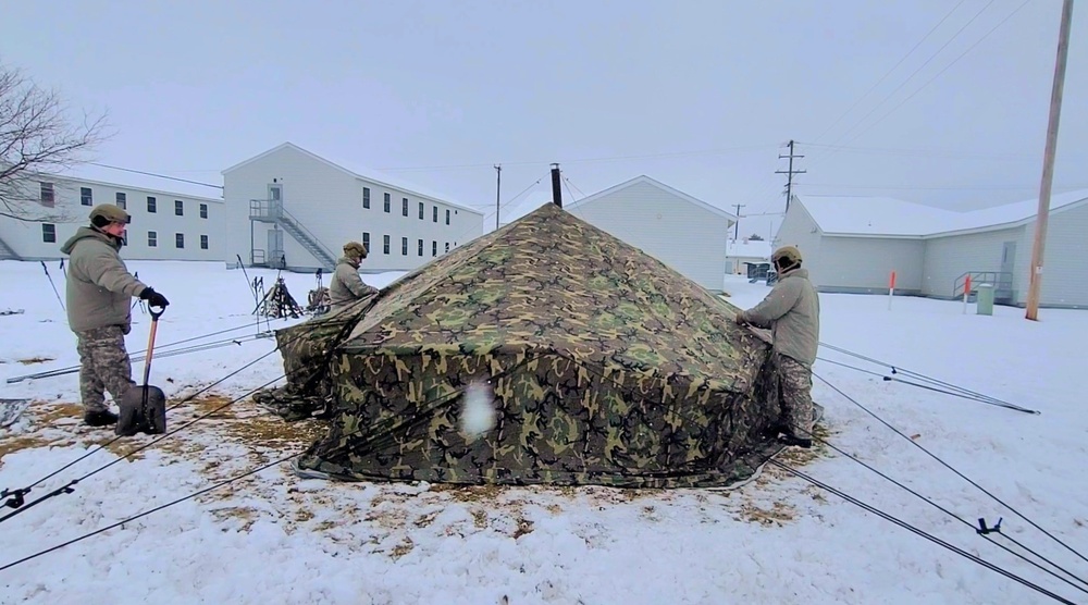 Airmen learn to build Arctic 10-person tents during cold-weather training at Fort McCoy