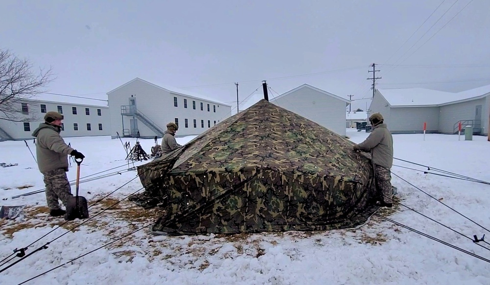 Airmen learn to build Arctic 10-person tents during cold-weather training at Fort McCoy