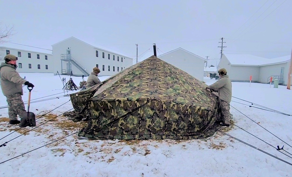 Airmen learn to build Arctic 10-person tents during cold-weather training at Fort McCoy