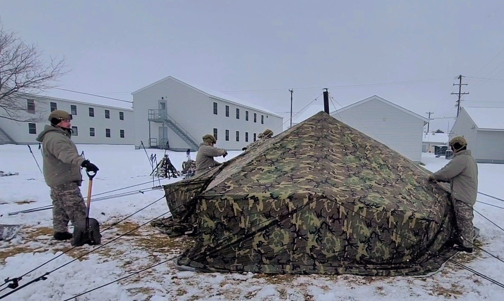 Airmen learn to build Arctic 10-person tents during cold-weather training at Fort McCoy