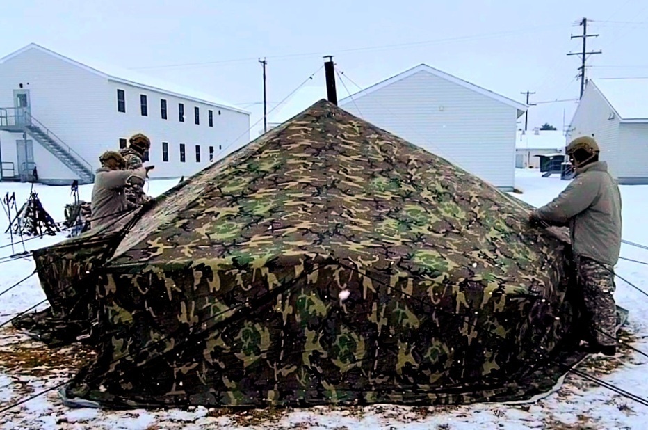 Airmen learn to build Arctic 10-person tents during cold-weather training at Fort McCoy