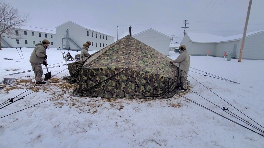 Airmen learn to build Arctic 10-person tents during cold-weather training at Fort McCoy