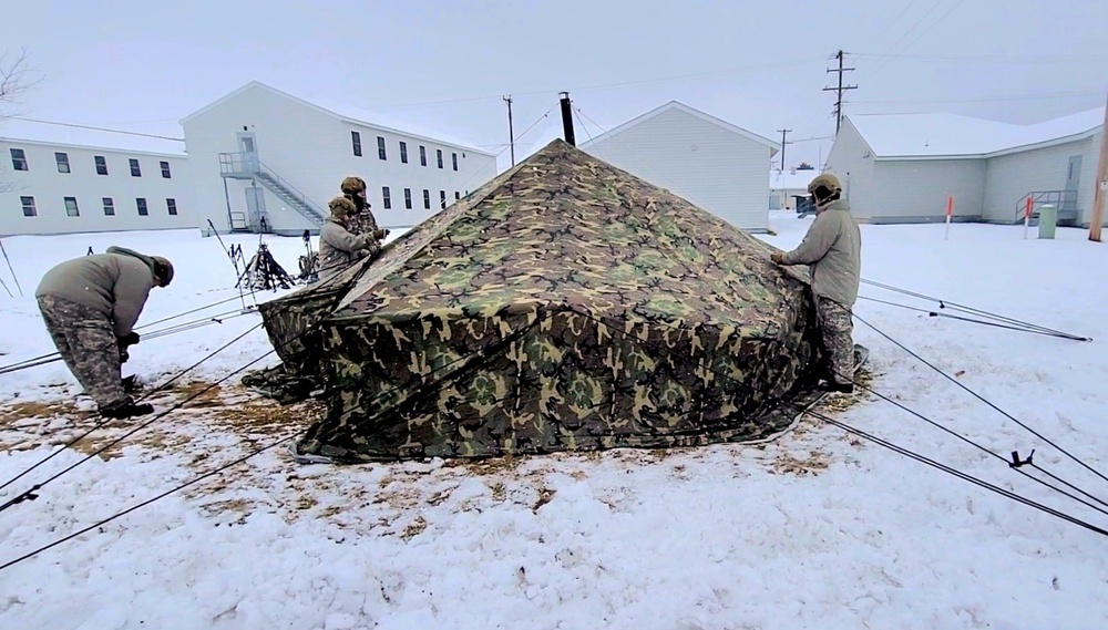 Airmen learn to build Arctic 10-person tents during cold-weather training at Fort McCoy