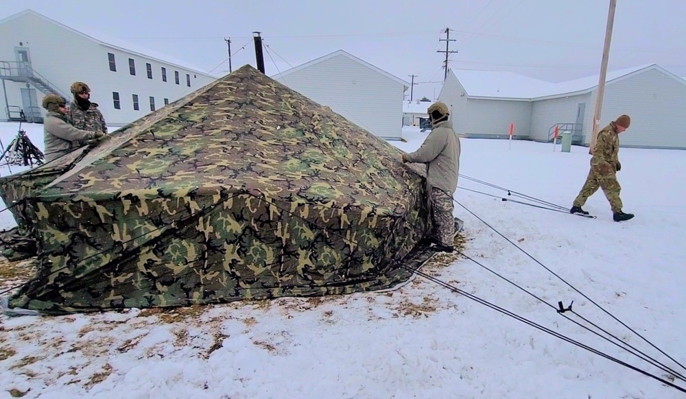 Airmen learn to build Arctic 10-person tents during cold-weather training at Fort McCoy