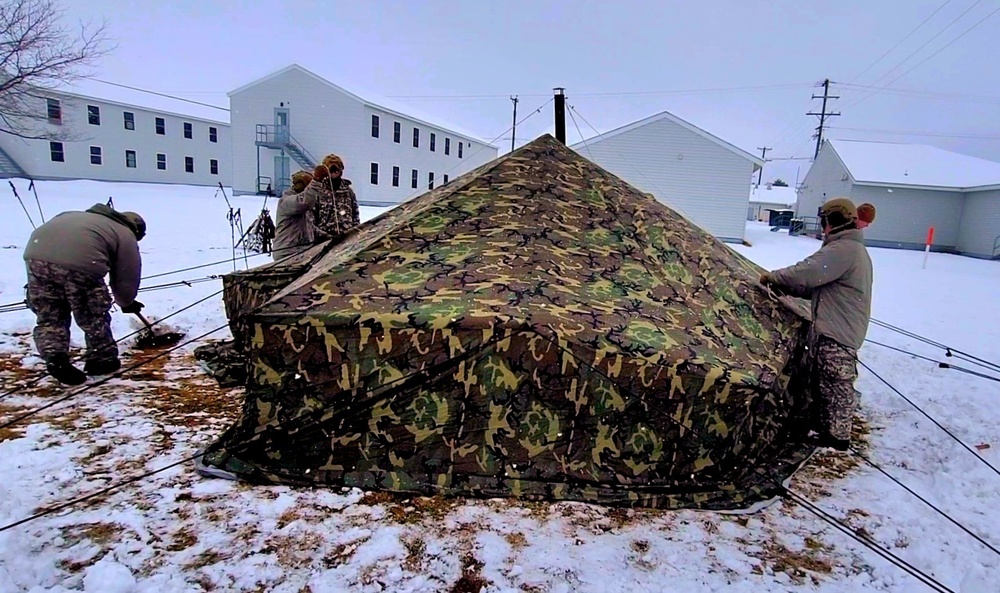 Airmen learn to build Arctic 10-person tents during cold-weather training at Fort McCoy