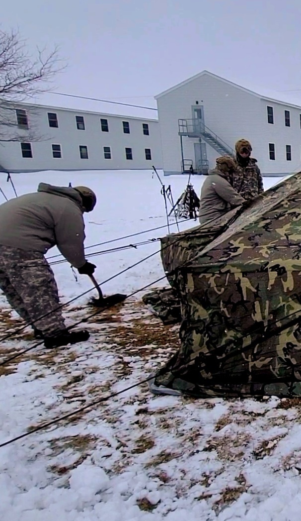 Airmen learn to build Arctic 10-person tents during cold-weather training at Fort McCoy