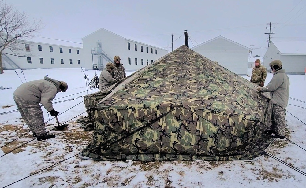 Airmen learn to build Arctic 10-person tents during cold-weather training at Fort McCoy