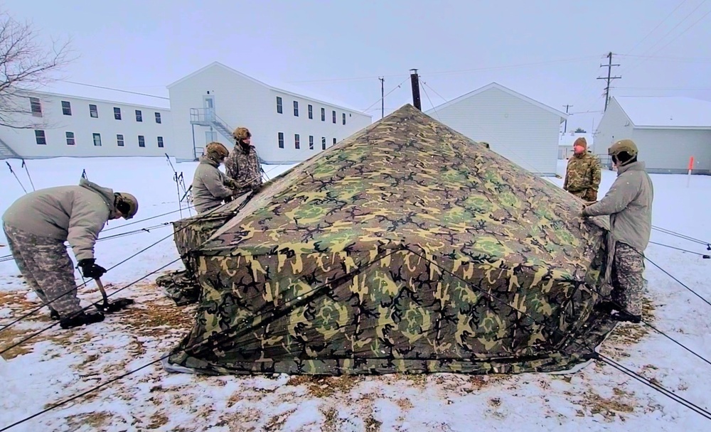 Airmen learn to build Arctic 10-person tents during cold-weather training at Fort McCoy