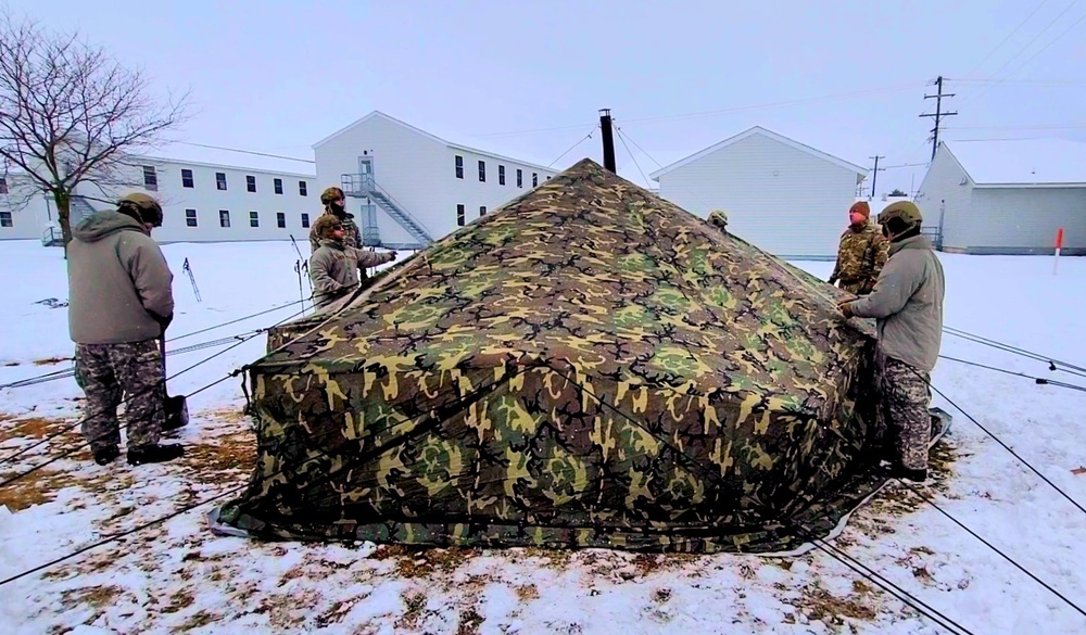 Airmen learn to build Arctic 10-person tents during cold-weather training at Fort McCoy