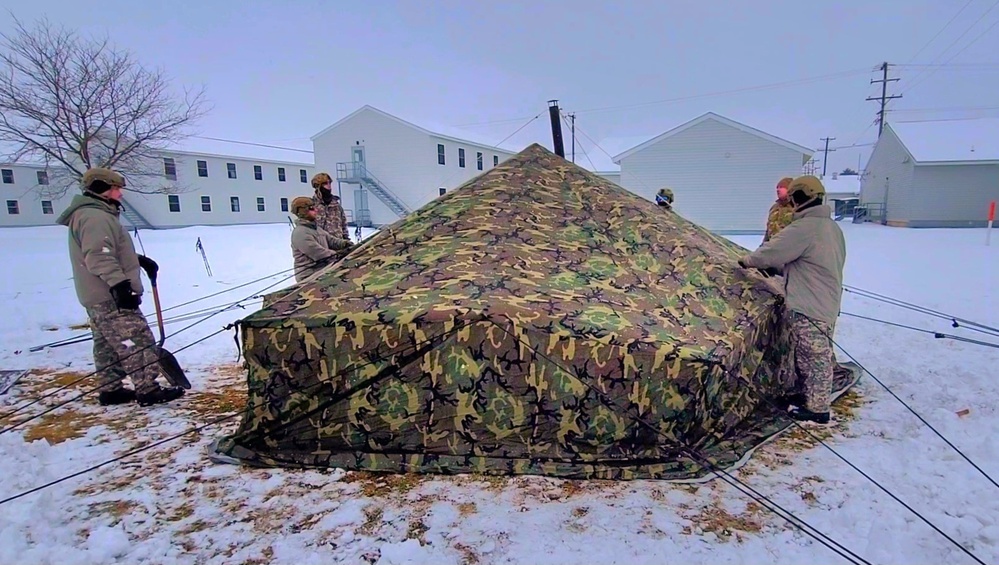 Airmen learn to build Arctic 10-person tents during cold-weather training at Fort McCoy