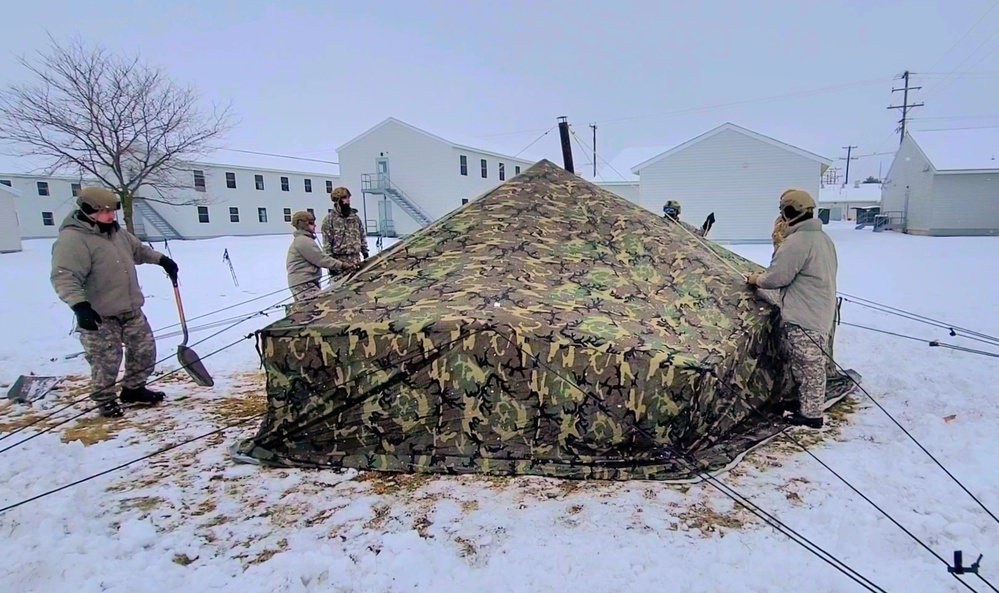 Airmen learn to build Arctic 10-person tents during cold-weather training at Fort McCoy