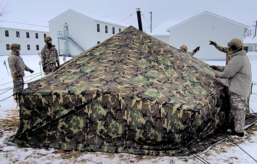 Airmen learn to build Arctic 10-person tents during cold-weather training at Fort McCoy