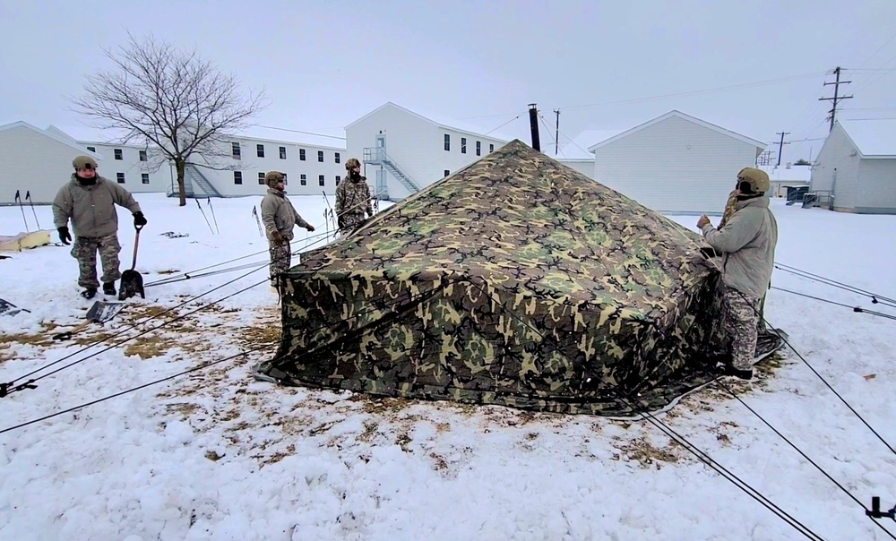 Airmen learn to build Arctic 10-person tents during cold-weather training at Fort McCoy