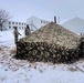 Airmen learn to build Arctic 10-person tents during cold-weather training at Fort McCoy