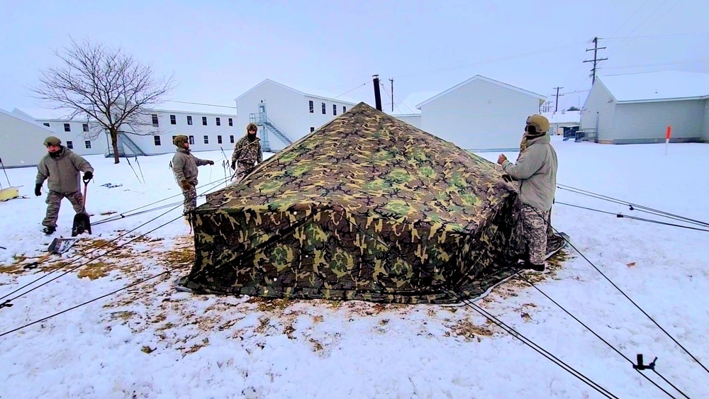 Airmen learn to build Arctic 10-person tents during cold-weather training at Fort McCoy