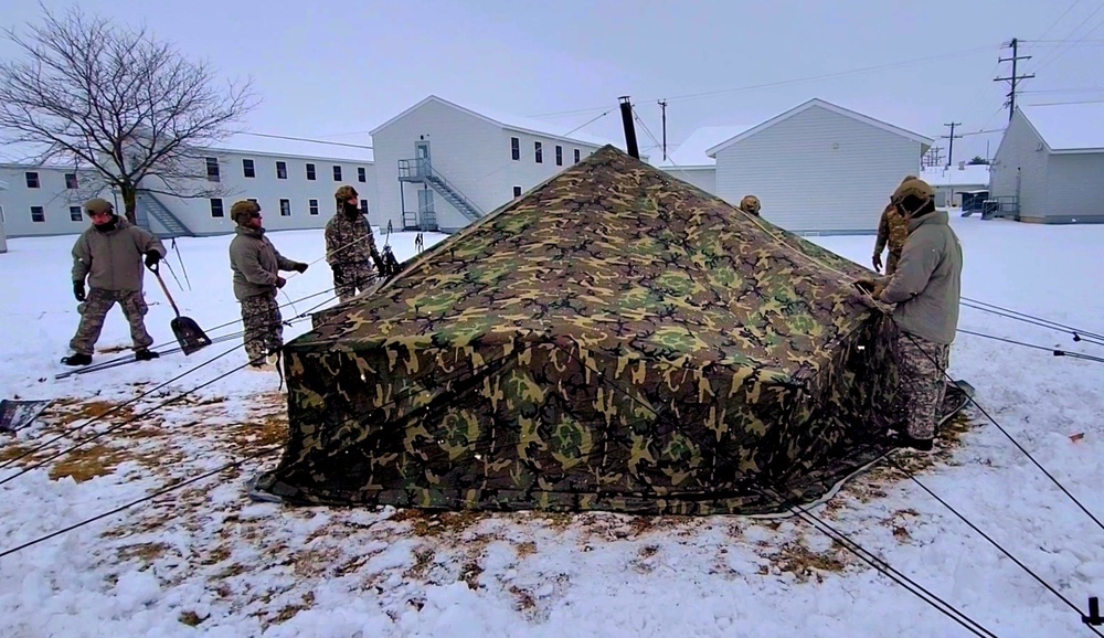 Airmen learn to build Arctic 10-person tents during cold-weather training at Fort McCoy