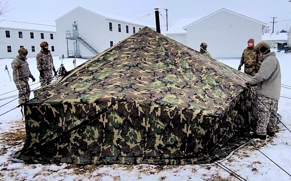 Airmen learn to build Arctic 10-person tents during cold-weather training at Fort McCoy