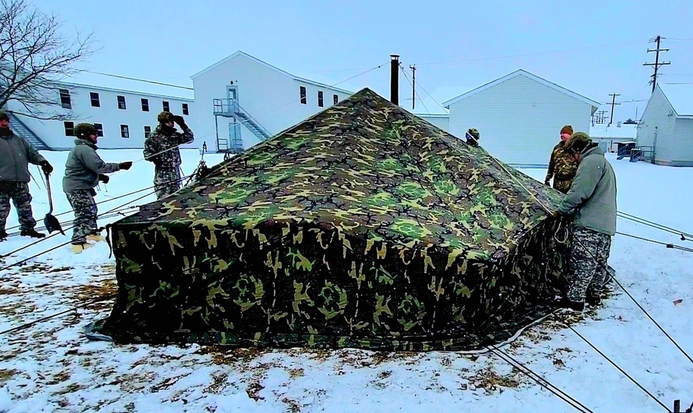 Airmen learn to build Arctic 10-person tents during cold-weather training at Fort McCoy