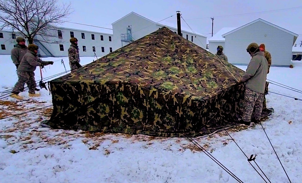 Airmen learn to build Arctic 10-person tents during cold-weather training at Fort McCoy