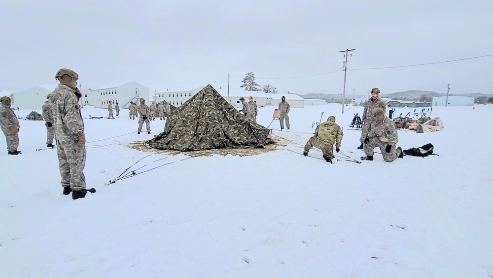 Airmen learn to build Arctic 10-person tents during cold-weather training at Fort McCoy