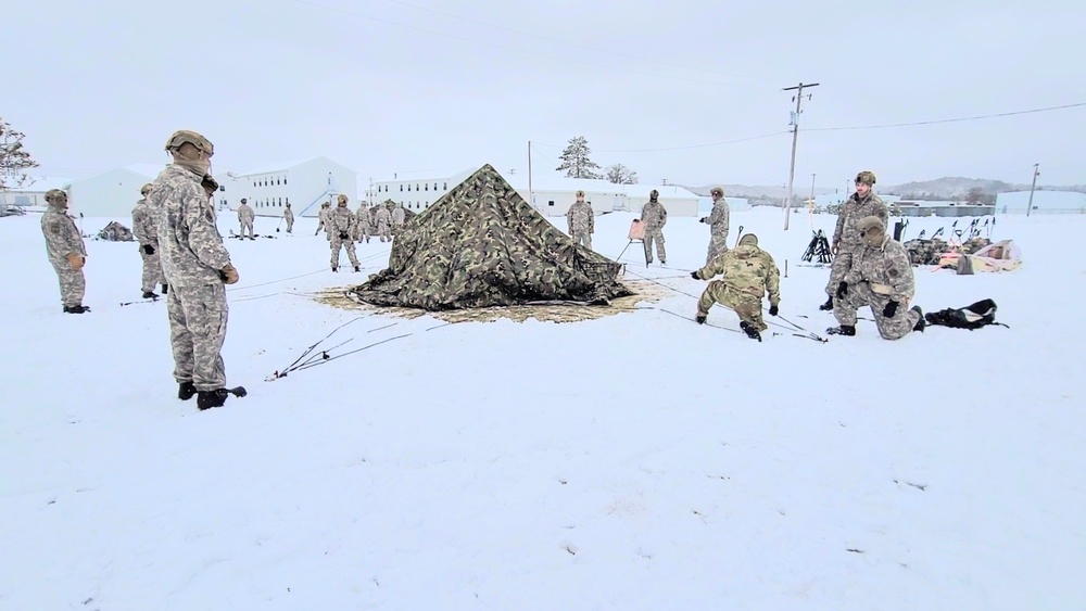 Airmen learn to build Arctic 10-person tents during cold-weather training at Fort McCoy