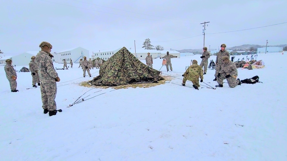 Airmen learn to build Arctic 10-person tents during cold-weather training at Fort McCoy