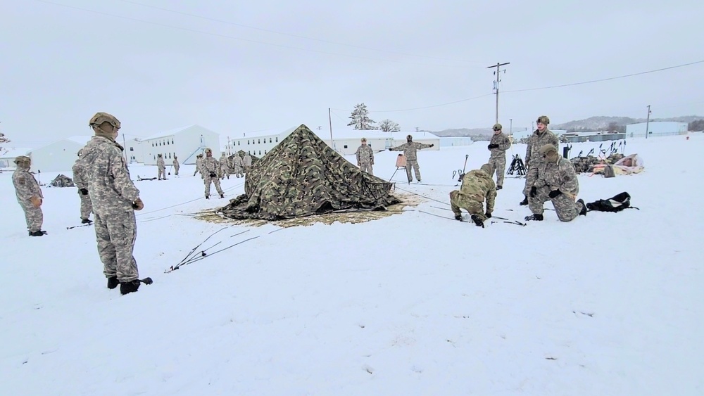 Airmen learn to build Arctic 10-person tents during cold-weather training at Fort McCoy