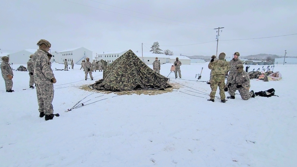 Airmen learn to build Arctic 10-person tents during cold-weather training at Fort McCoy