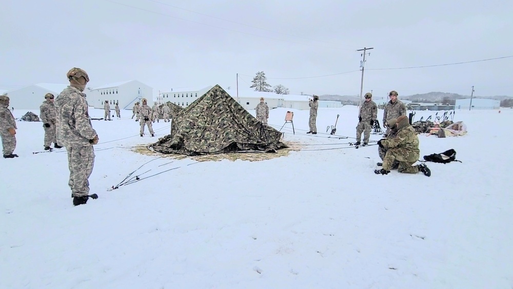 Airmen learn to build Arctic 10-person tents during cold-weather training at Fort McCoy