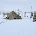 Airmen learn to build Arctic 10-person tents during cold-weather training at Fort McCoy