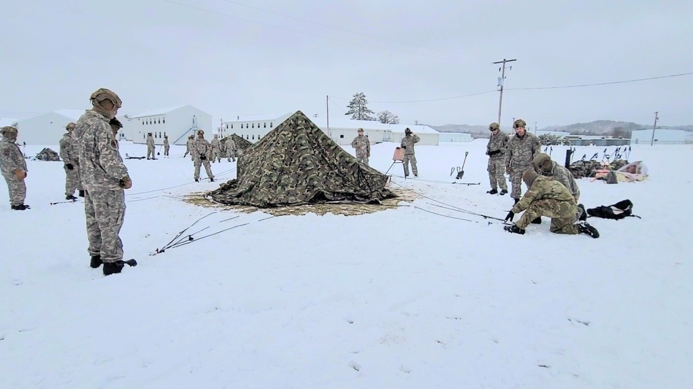 Airmen learn to build Arctic 10-person tents during cold-weather training at Fort McCoy