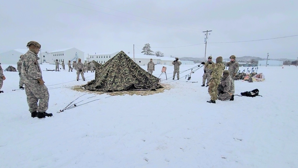 Airmen learn to build Arctic 10-person tents during cold-weather training at Fort McCoy